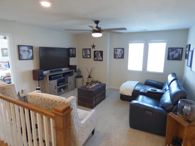 a bedroom with a bed a couch and dresser