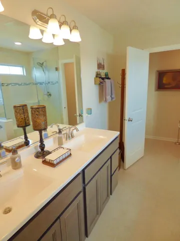a bathroom with a granite countertop sink a toilet and shower