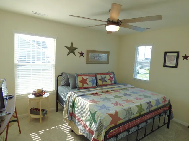 a bathroom with a granite countertop sink a toilet and a mirror