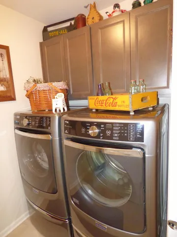 a view of a patio with couches table and chairs under an umbrella