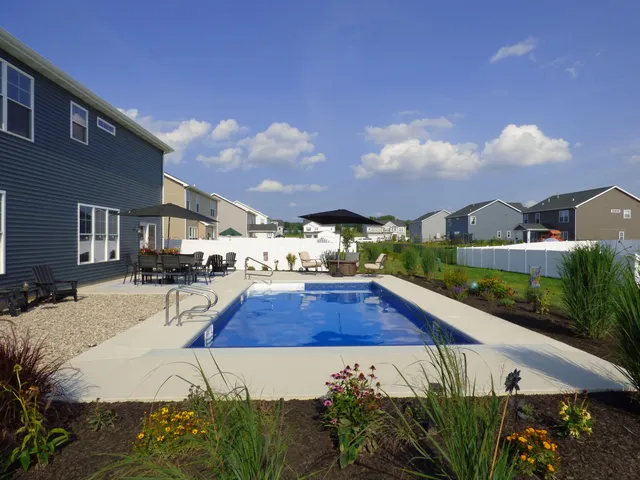 a view of a house with pool and sitting area