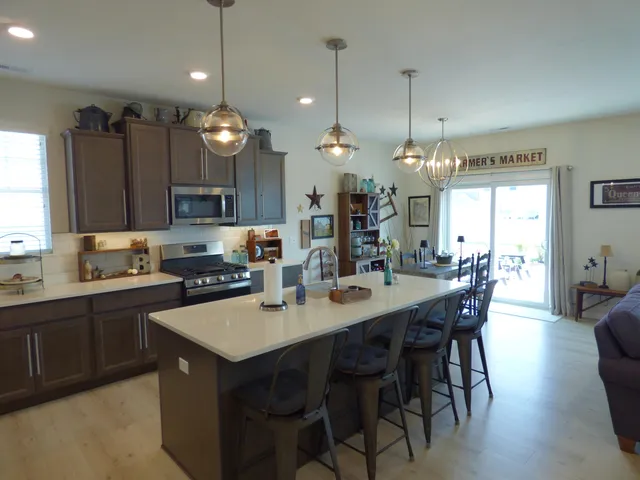 a large kitchen with a table and chairs