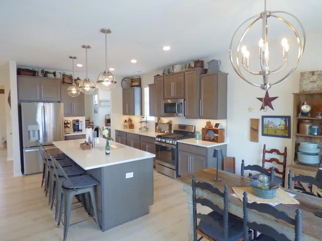 a large kitchen with a table and chairs