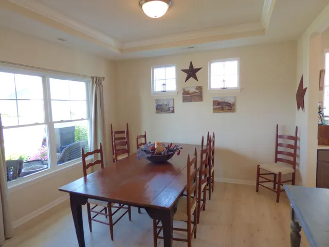 a view of a dining room with furniture and a large window