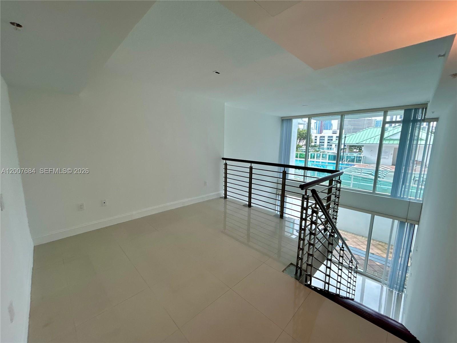 41 Southeast 5th Street, Unit 703 Miami, FL 33131 - Photo 2 of 18 wooden floor in an empty room with a window