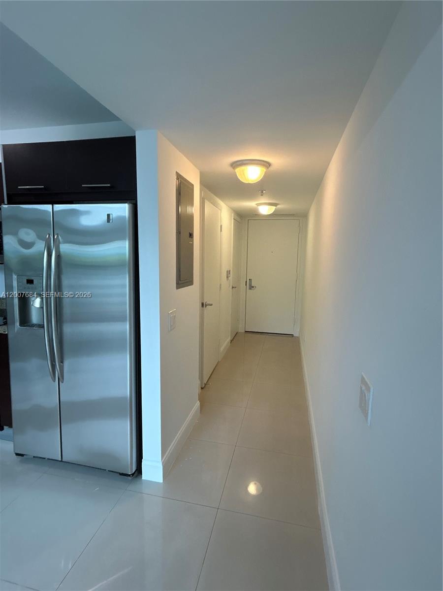 41 Southeast 5th Street, Unit 703 Miami, FL 33131 - Photo 6 of 18 a view of a hallway with wooden shelves