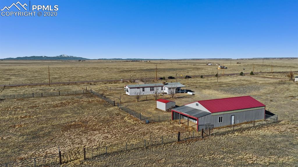 4685 Yoder Road Yoder, CO 80864 - Photo 5 of 32 11 x 30 Loafing shed attached to the barn, and accessible through the arena.