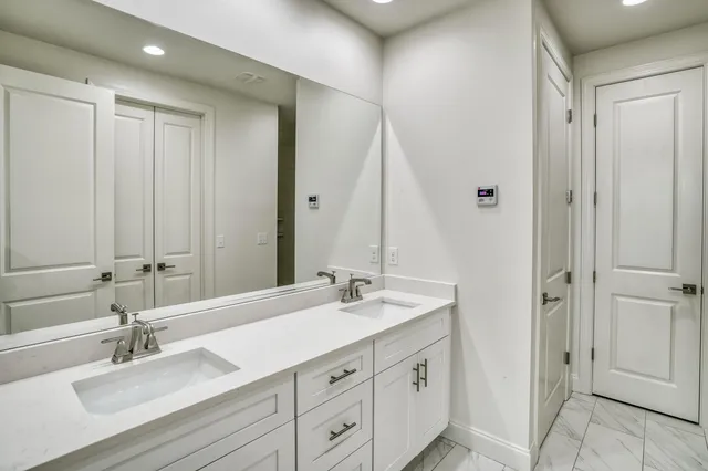 a bathroom with a double vanity sink mirror and