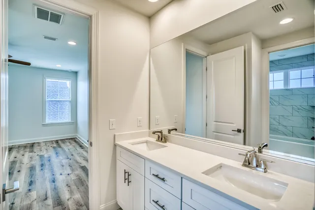 a bathroom with a double vanity sink mirror and double