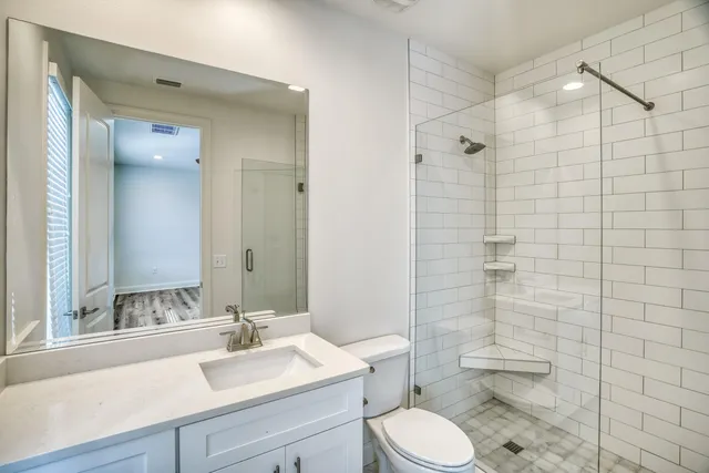a bathroom with a sink toilet and shower