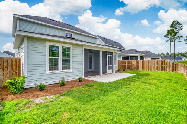a view of a house with backyard and porch