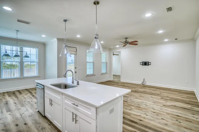 a kitchen with sink stove and refrigerator