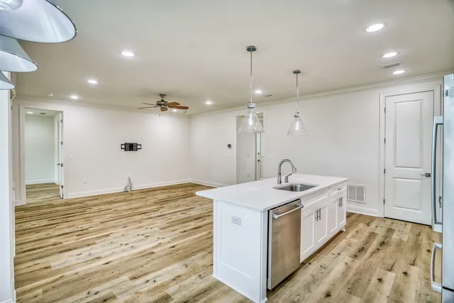 a kitchen with a sink and a stove top oven