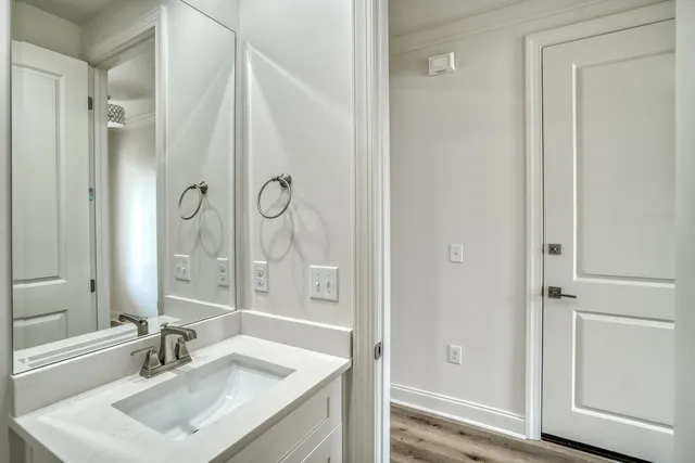 a bathroom with a sink vanity granite tub and shower