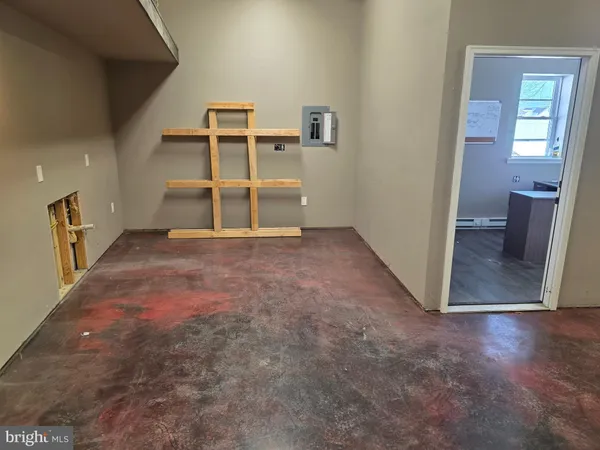 a small space with wooden floor and a window