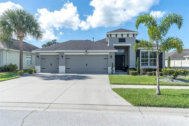 a front view of a house with a yard and garage