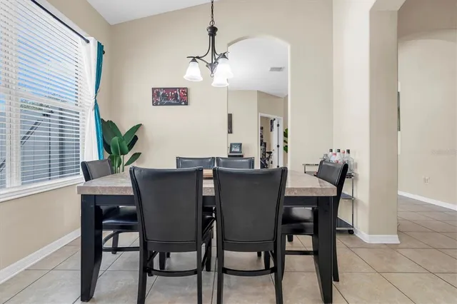 a view of a dining room with furniture and window