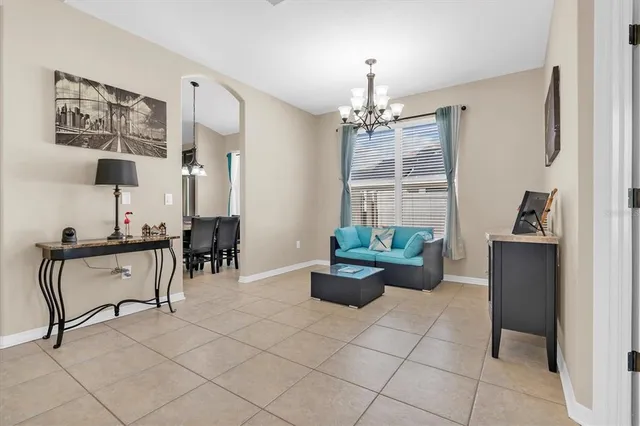 a living room with furniture and a chandelier