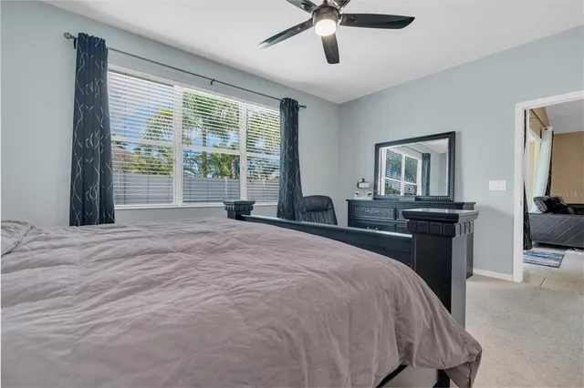 a bedroom with a large bed and a chandelier