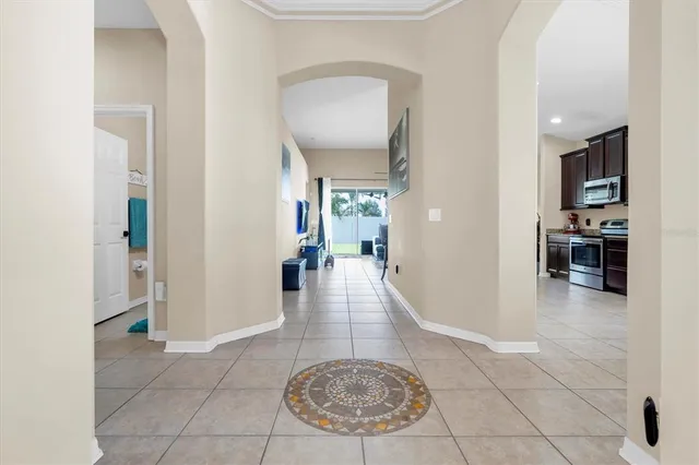 a view of a hallway with furniture and a dining room