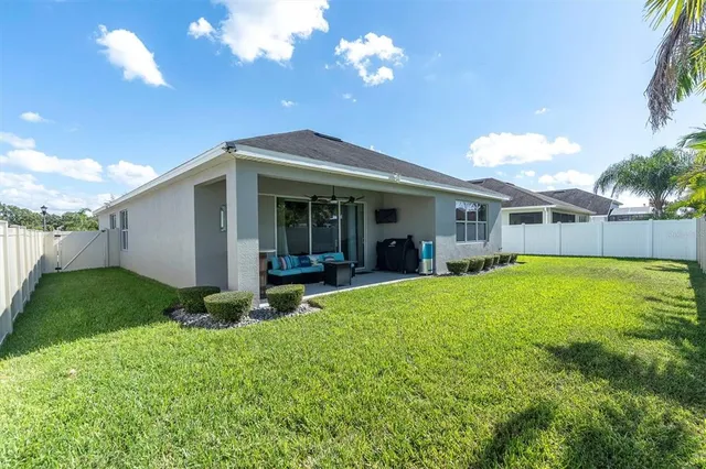 a view of a house with pool and a yard