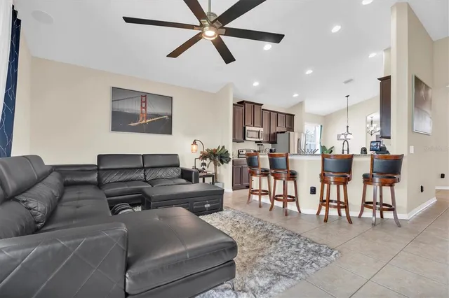 a living room with furniture and kitchen view