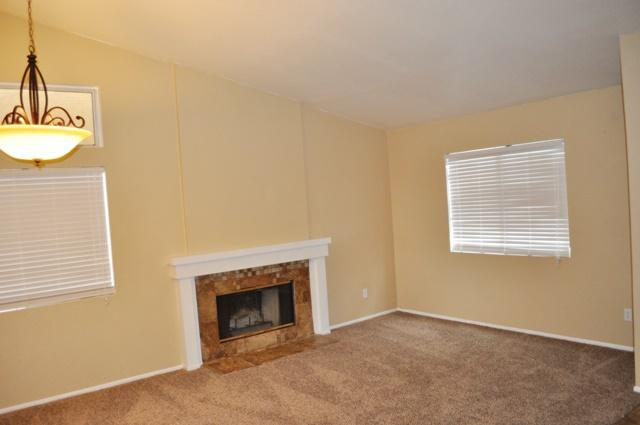 3153 Quarry Road Palmdale, CA 93550 - Photo 2 of 21 a view of an empty room with a fireplace and a window