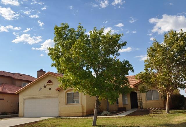 3153 Quarry Road Palmdale, CA 93550 - Photo 21 of 21 a front view of a house with a yard and garage