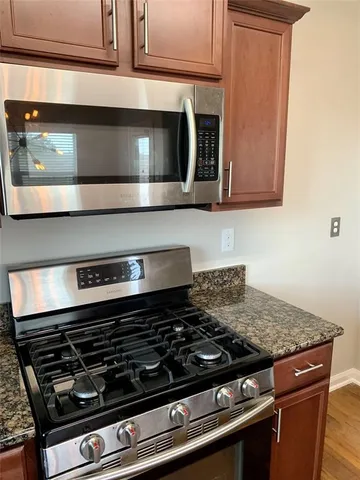 a stove top oven sitting inside of a kitchen