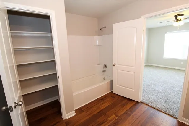 a view of bathroom with bathtub and shower