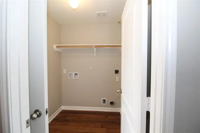 a view of room with walk in closet and wooden floor