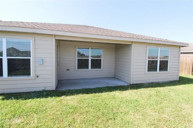 a view of house with backyard and garden