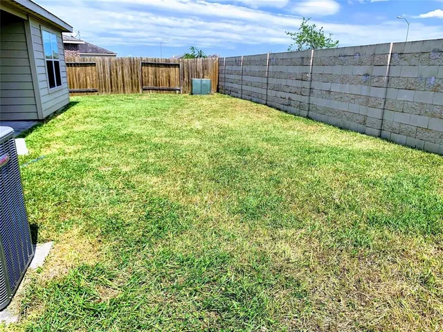 a view of a backyard with a wooden fence