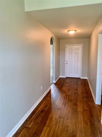 a view of a room with wooden floor and window