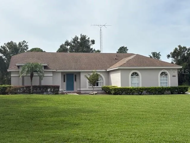 a front view of house with yard and green space