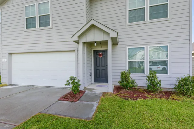 a view of a house with a yard and plants