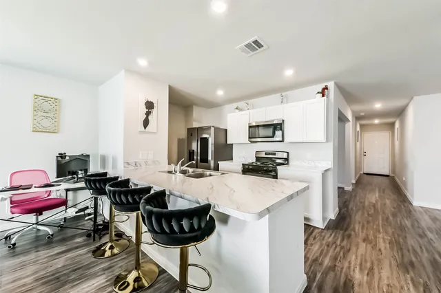 a view of a dining room kitchen and a wooden floor