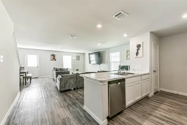 a kitchen with a sink and cabinets