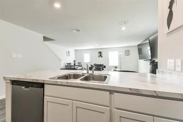 a kitchen with a sink and a refrigerator