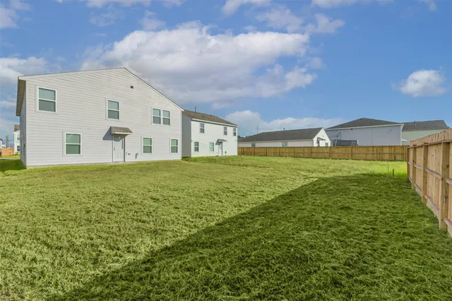 a view of a big yard with an ocean view