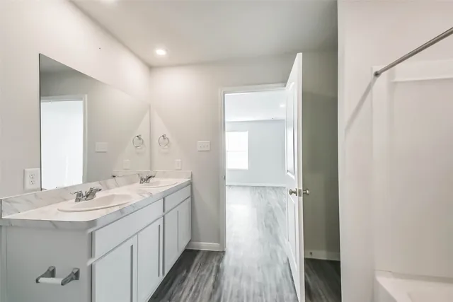 a bathroom with a double vanity sink and mirror