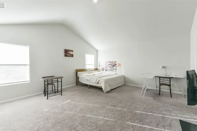 a bedroom with a bed chair and a window