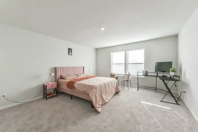 a bed room with a bed and a chair