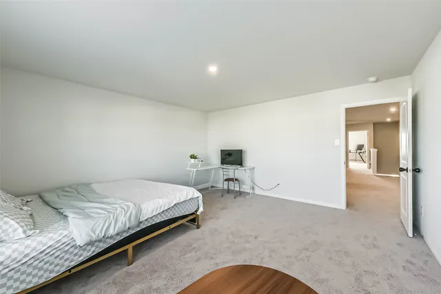 a bedroom with a bed and a lamp