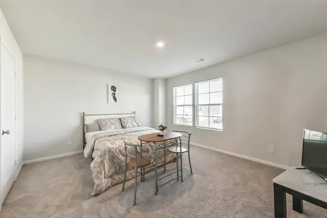 a bed room with a bed and a window