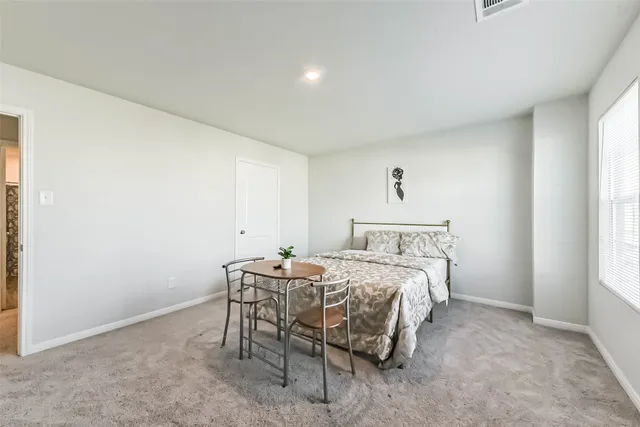 a bed room with a bed and a window