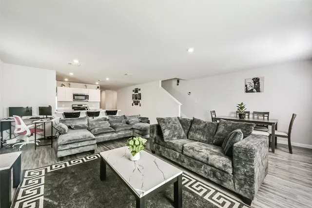 a living room with furniture a wooden floor and a couch