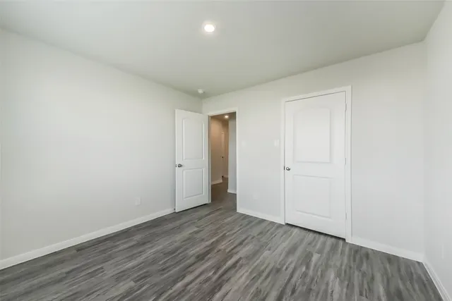 a view of an empty room and wooden floor