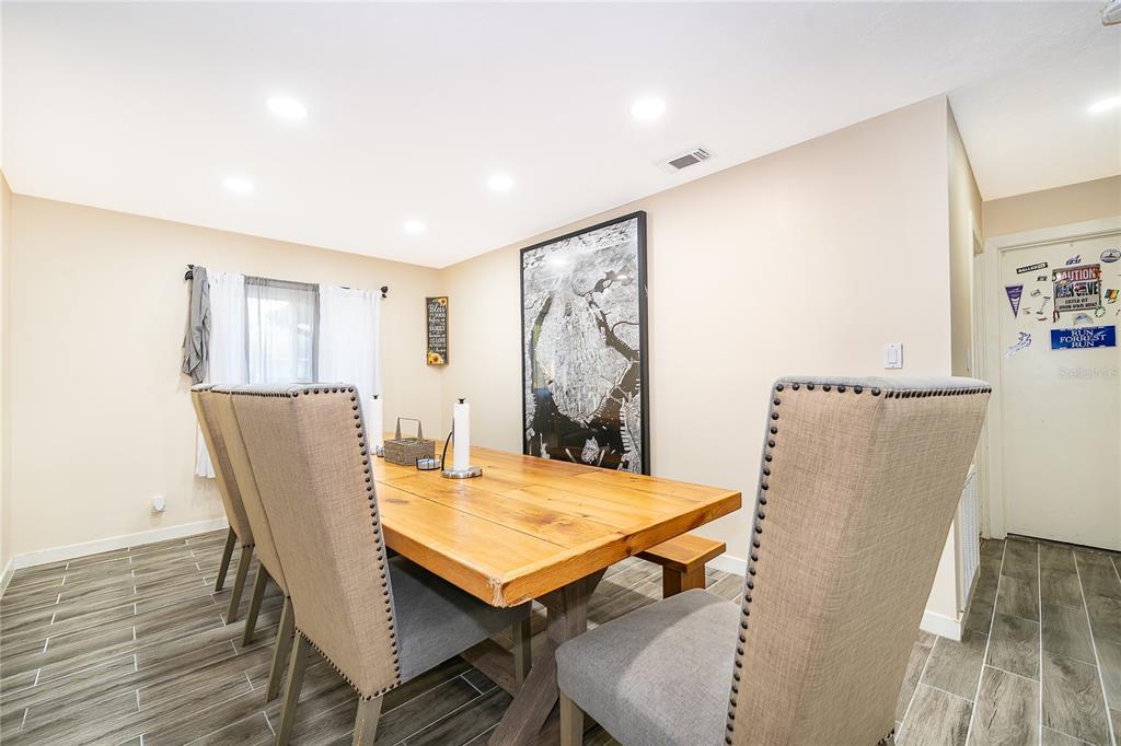 2350 Wekiva Ridge Road Apopka, FL 32712 - Photo 11 of 34 a view of a dining room with furniture and wooden floor