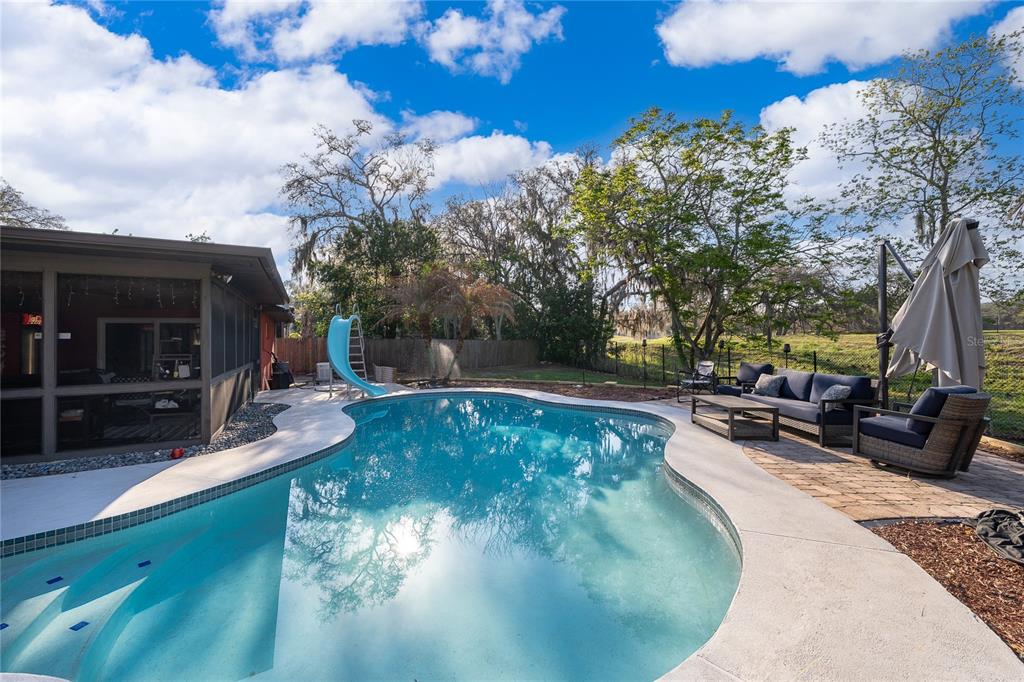 2350 Wekiva Ridge Road Apopka, FL 32712 - Photo 18 of 34 a view of a swimming pool with sitting area